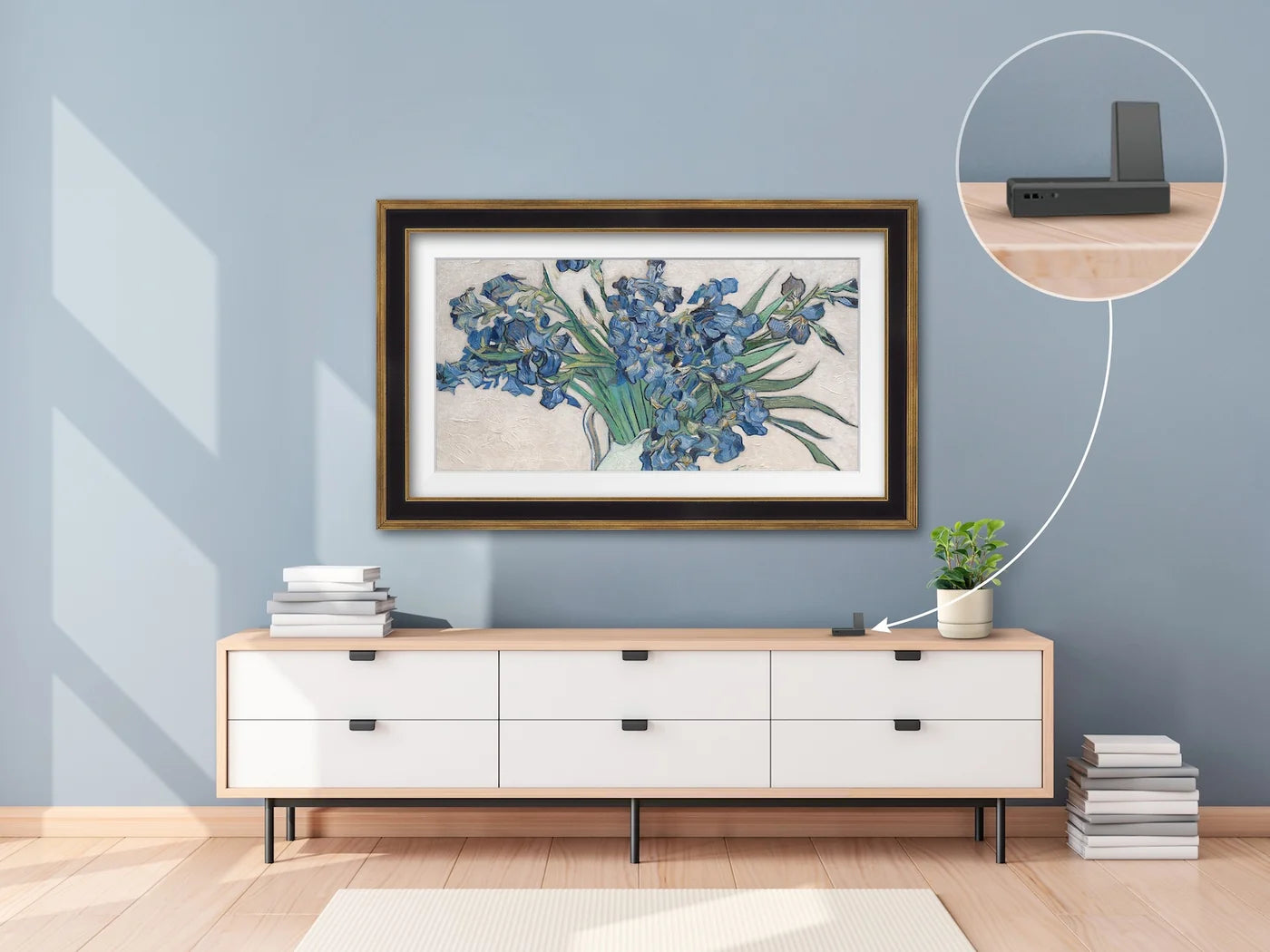 Framed artwork of flowers on a wall above a wooden console table.