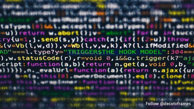 Software developer programming code on black background